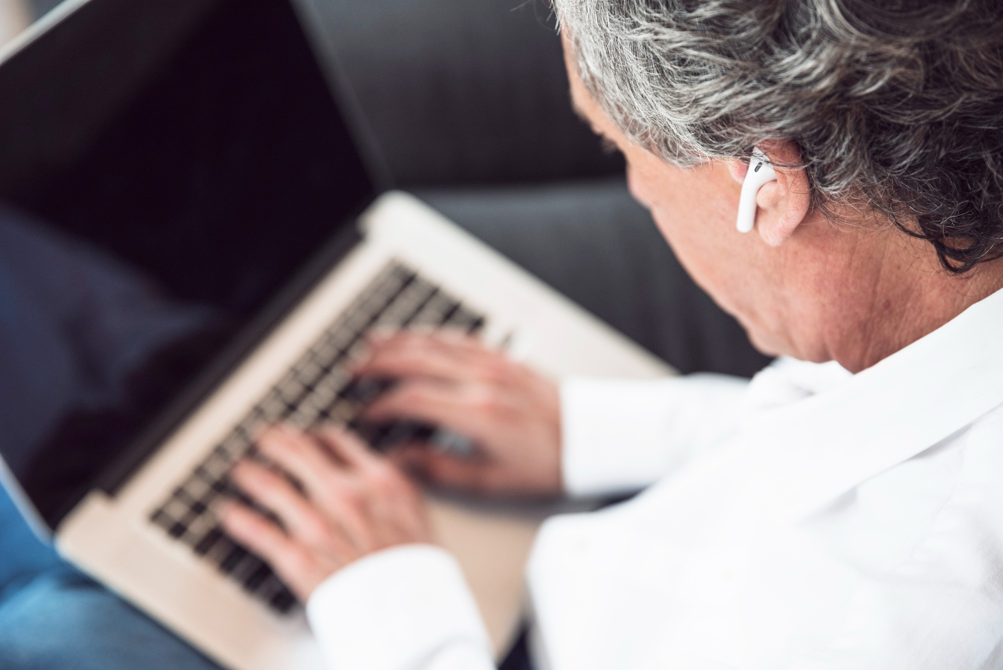 Professional reviewing multilingual content on a laptop for a machine translation workflow